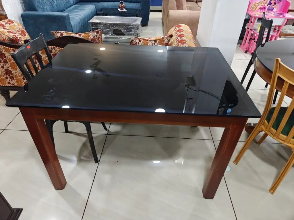 Glass top dining table with wooden legs